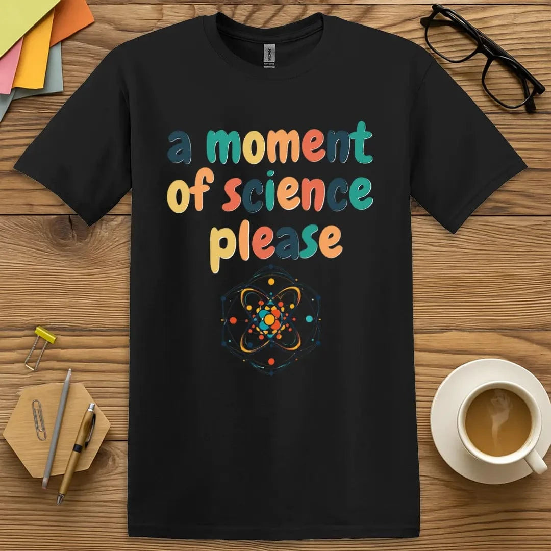 Black tee with rainbow text “A Moment of Science Please” and a stylized atom — a sharp, high-contrast choice for science fans and pun enthusiasts.