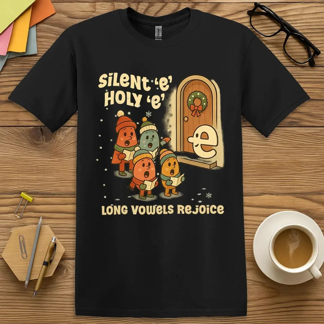 Black T-shirt with "Silent e Holy e Long Vowels Rejoice" design featuring festive vowel carolers and grammar humor.