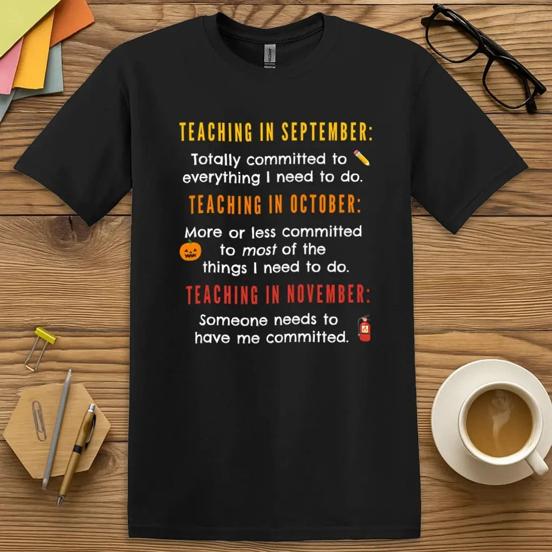 Black Color T-shirt with "Teaching in September... October... November..." design offering sleek style and a wearable staffroom meme.