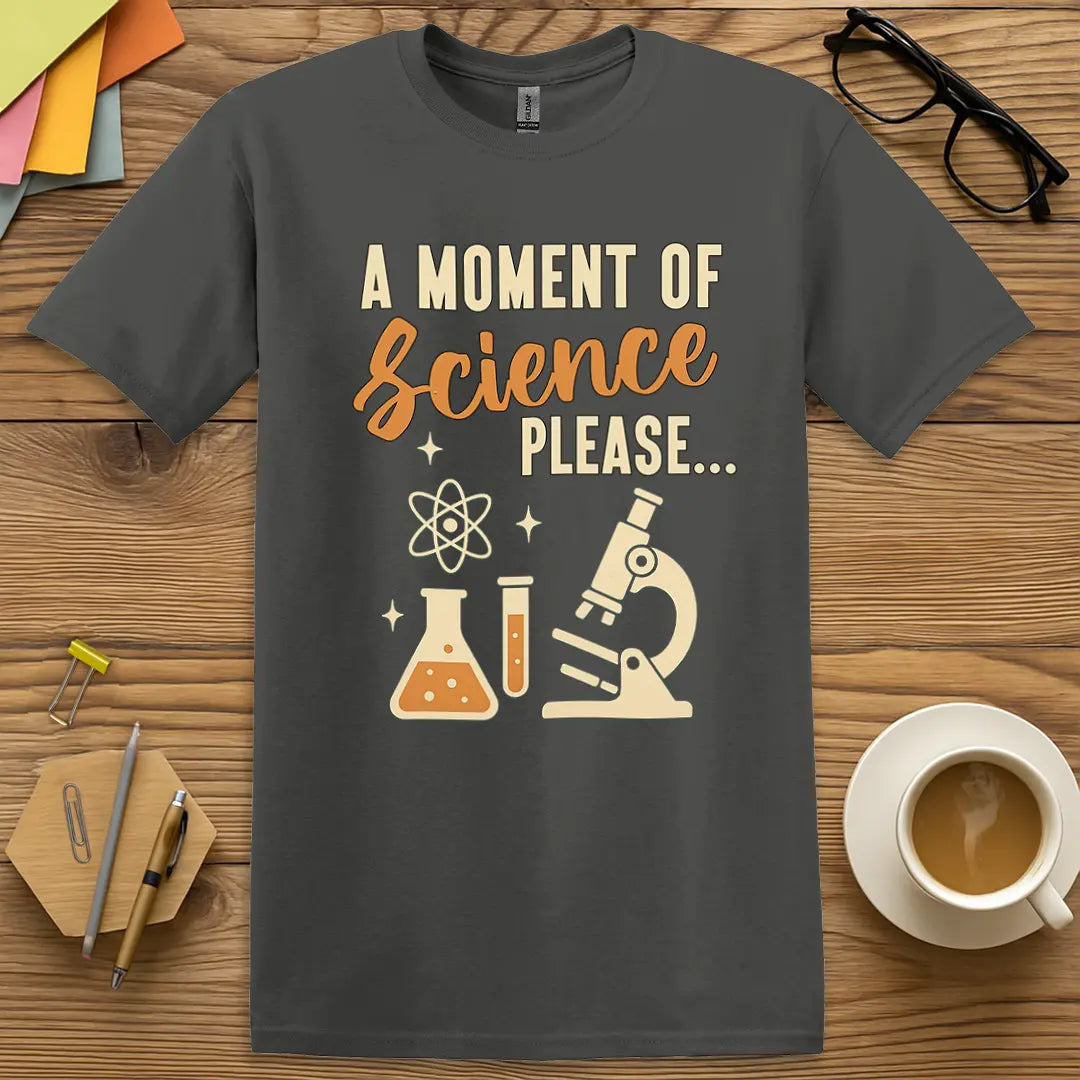 Charcoal T-shirt with "A Moment of Science Please..." design showcasing test tubes, atom graphic, and witty teacher humor.