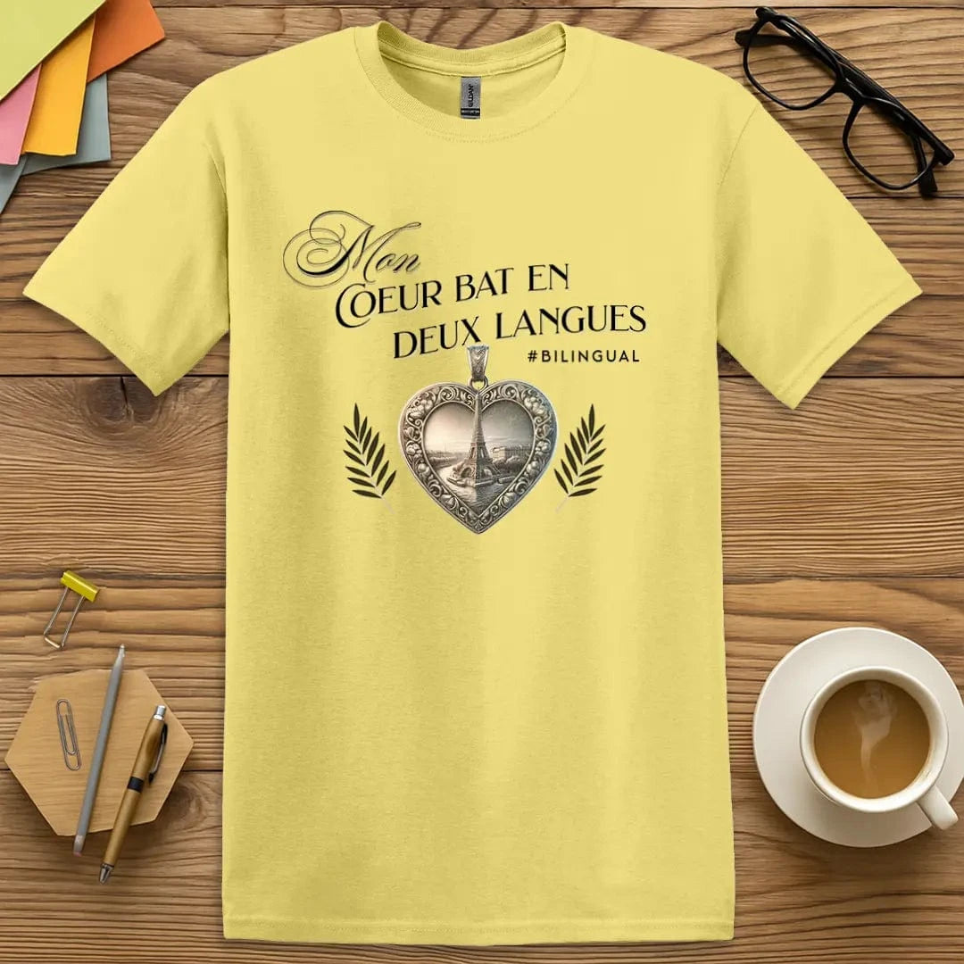 Cornsilk T-shirt with “Mon cœur bat en deux langues” design featuring an ornate heart pendant and Eiffel Tower – sunny and sweet for the multilingual soul