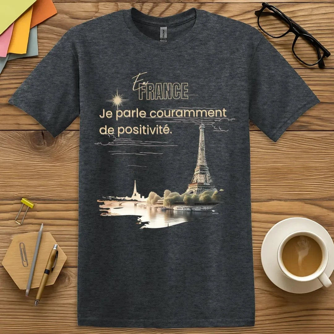 Dark Heather T-shirt with “En France, je parle couramment de positivité” design featuring cozy classroom style with a French twist