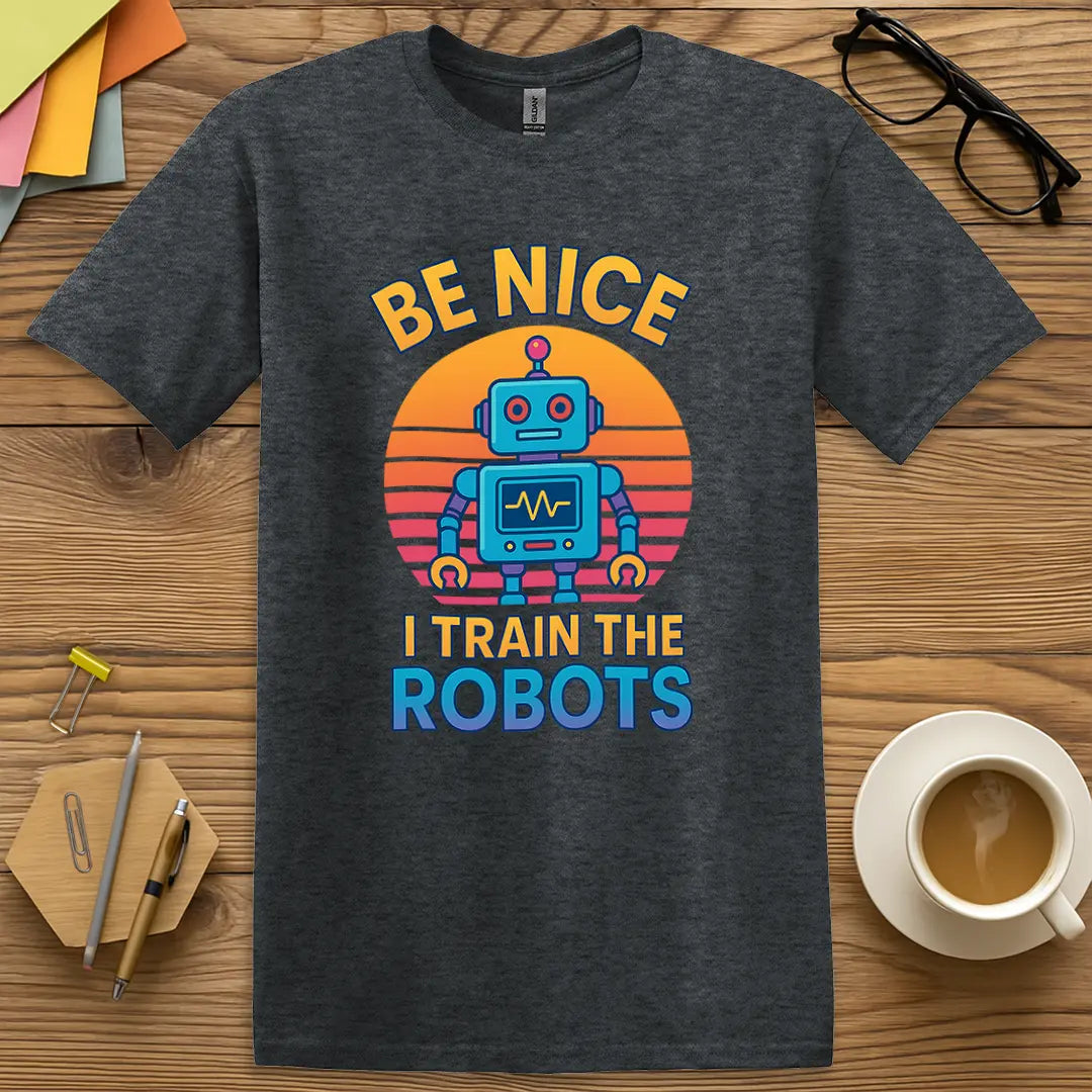 Dark Heather Color T-Shirt with "Be Nice I Train The Robots" design featuring cool tones and witty nerd pride appeal.