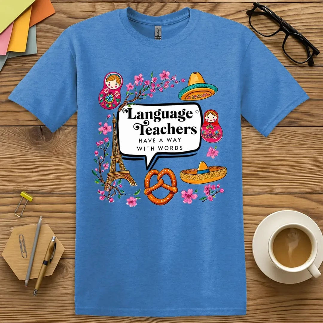 Heather Royal T-shirt with “Language teachers have a way with words” design featuring colorful cultural symbols in a teacher-empowering style