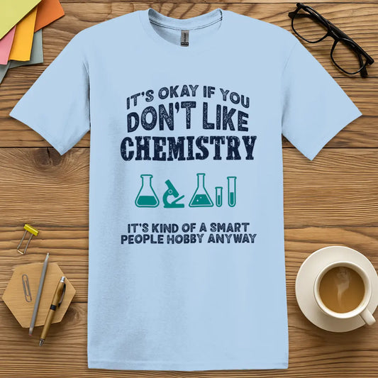 Light Blue Color T-shirt with It’s Okay if You Don’t Like Chemistry, It’s Kind of a Smart People Hobby Anyway design showing crisp lab tools and dry academic humor.