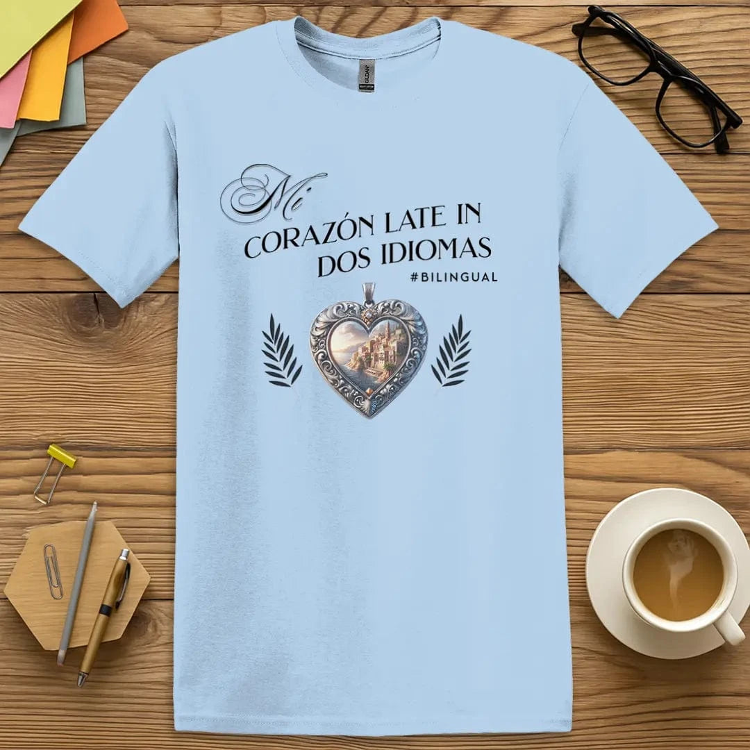 Light Blue T-shirt with “Mi corazón late en dos idiomas” design featuring Spanish coastal heart symbol