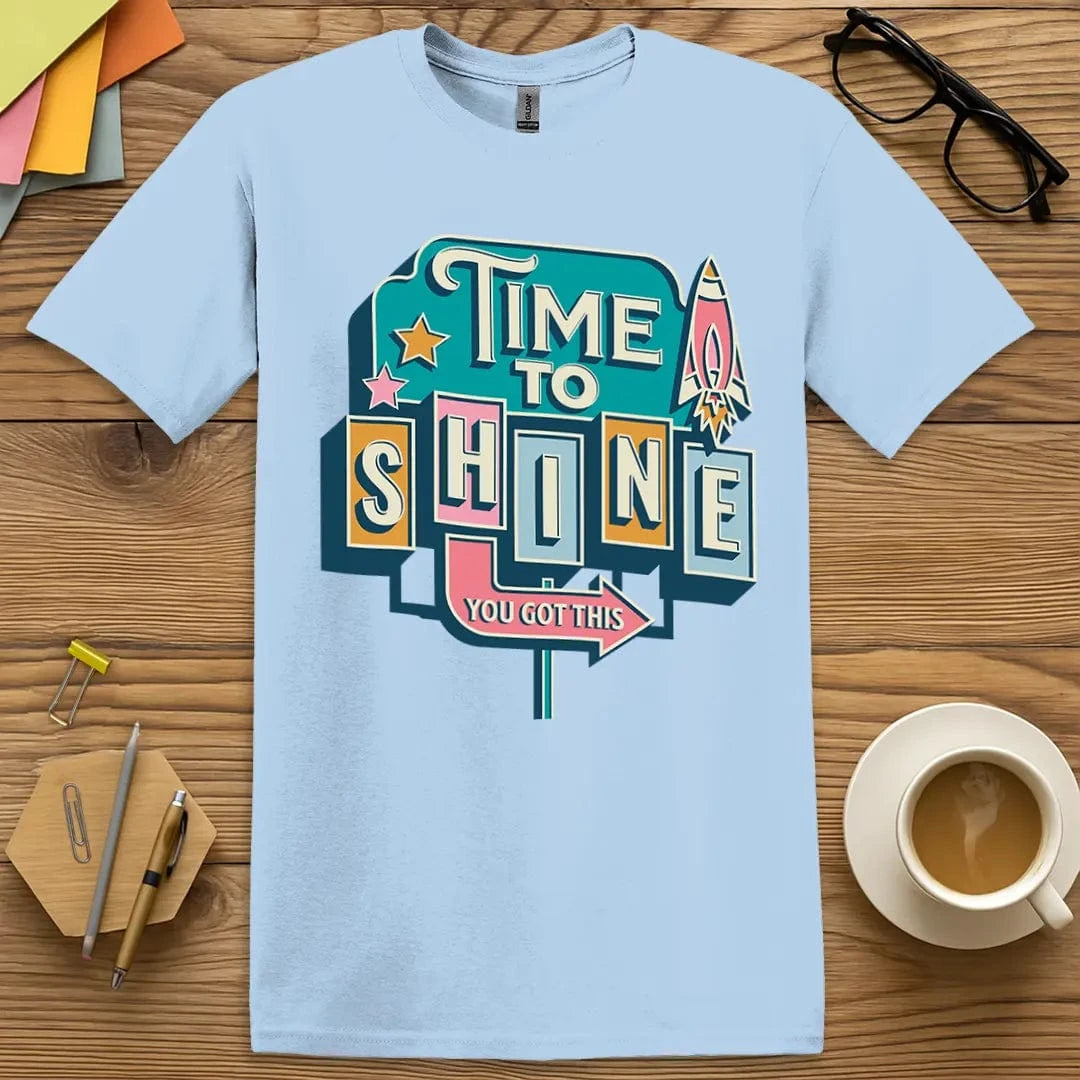 Light Blue Color T-Shirt with "Time to Shine You Got This" design featuring retro signage style, rocket detail, and uplifting classroom energy.