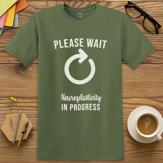 Military Green Color T-Shirt with "Please Wait Neuroplasticity In Progress" design showcasing a cognitive reboot vibe with nerdy charm.