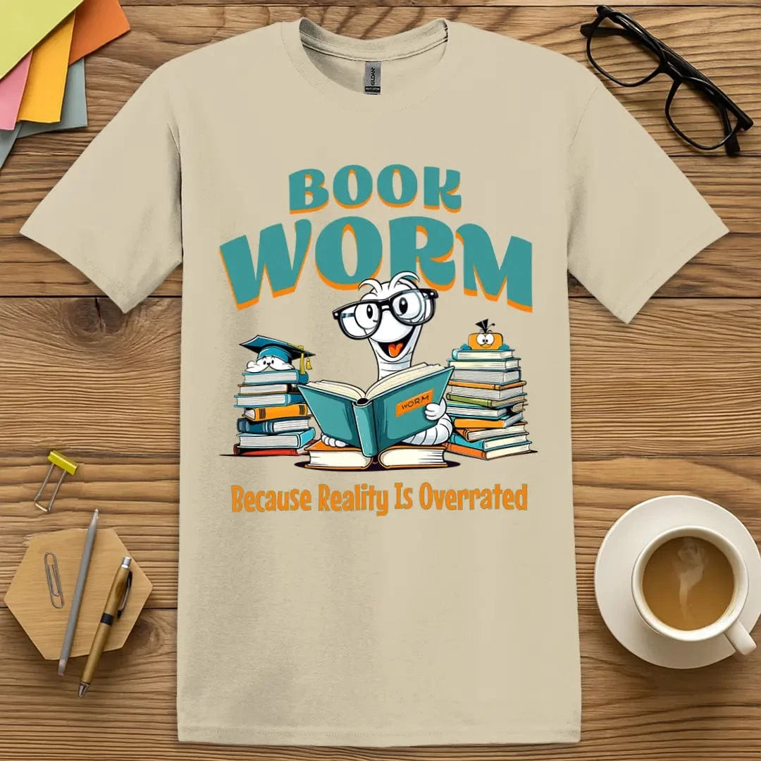 Sand T-shirt with “Book Worm – Because Reality Is Overrated” design and cute cartoon worm, perfect for teachers who live in stories