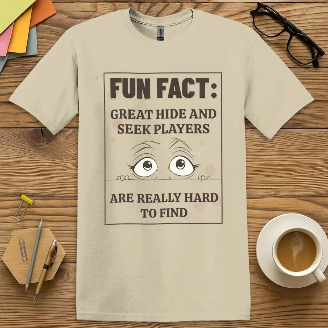 Sand Color T-Shirt with "Fun Fact: Great Hide and Seek Players Are Really Hard to Find" design offering neutral style with hilarious hide-and-seek twist.