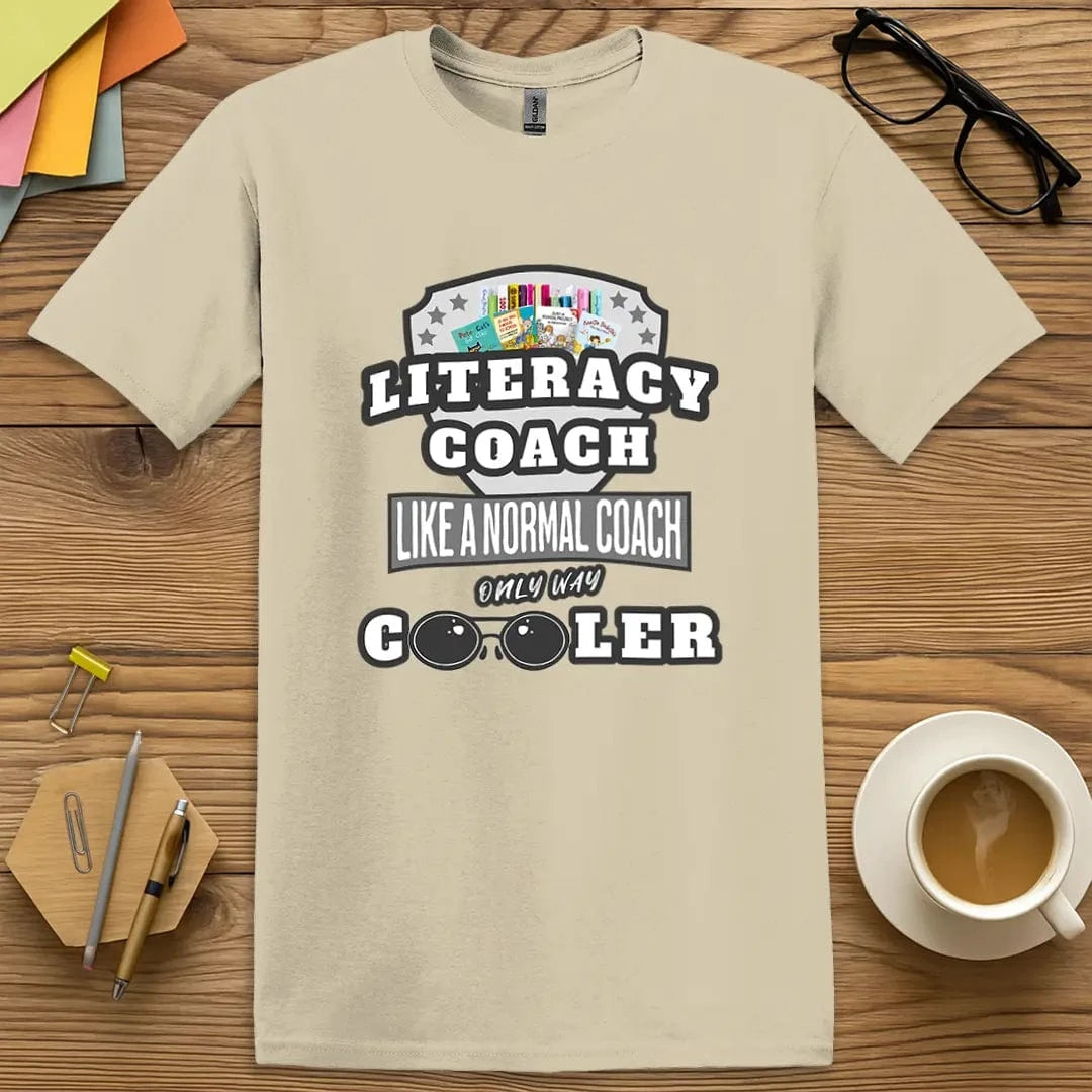 Sand Color T-Shirt with "Literacy Coach Like a Normal Coach Only Way Cooler" design mixing warm neutral tones with classroom pride.
