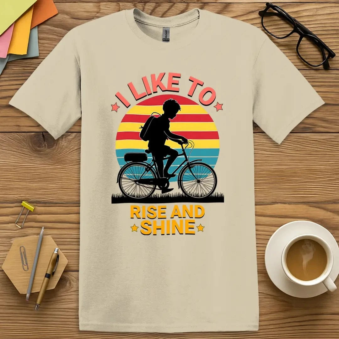 Sand Color T-shirt with "I Like to Rise and Shine" design featuring early morning humor and classic silhouette.