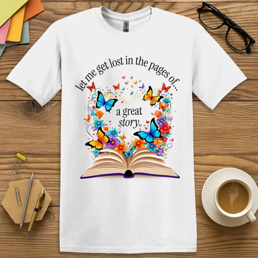 White Lost In The Pages T-Shirt – Crisp white tee with a burst of butterflies and flowers from an open book, symbolizing the escapism of great stories.
