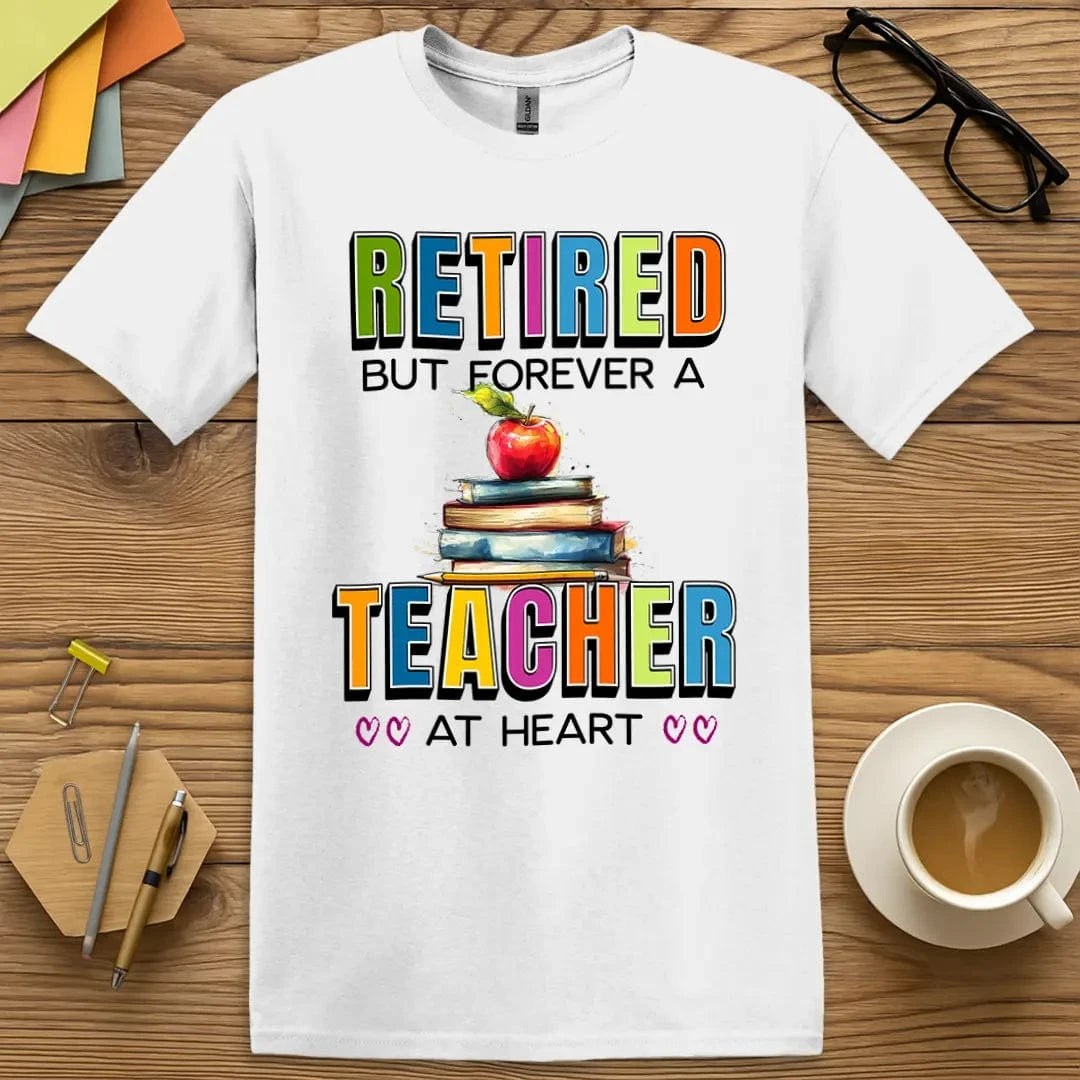 White Color T-shirt with "Retired But Forever a Teacher at Heart" design offering bold colors and heartfelt classroom tribute.