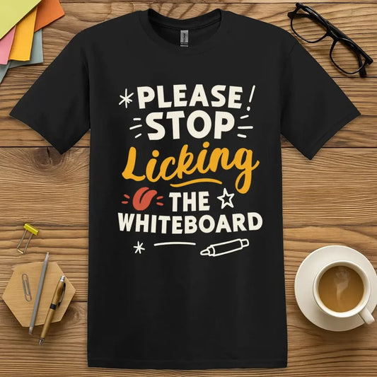 Black shirt with bold white, orange, and red text: Please Stop Licking the Whiteboard, with a cartoon whiteboard marker illustration