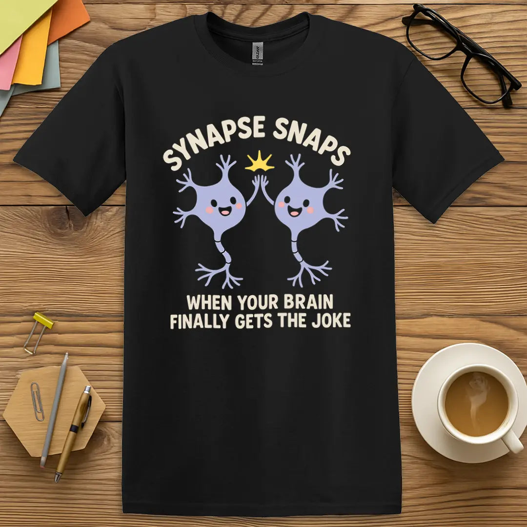 Black Color T-shirt with "Synapse Snaps: When Your Brain Finally Gets the Joke" design offering strong contrast for bold, nerdy humor.