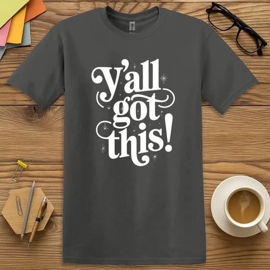 Charcoal T-shirt with “Y’all Got This!” design featuring bold white lettering and sparkly accents for motivational classroom energy