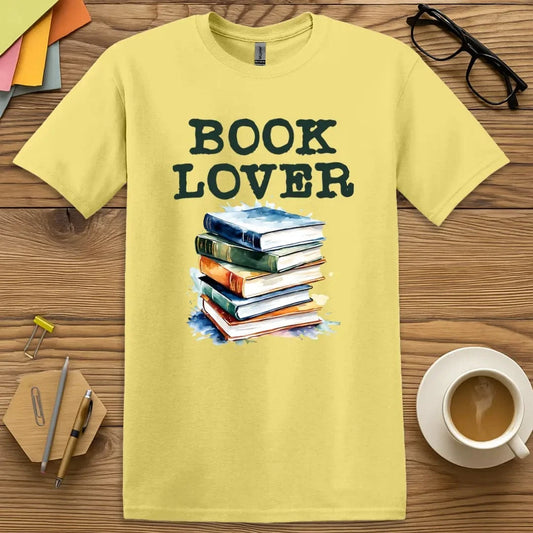 Cornsilk T-shirt with “Book Lover” text and watercolor book stack — bright, fun, and perfect for passionate readers and classroom champions  