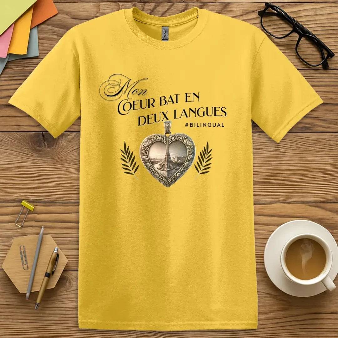 Daisy T-shirt with “Mon cœur bat en deux langues” design featuring an ornate heart pendant and Eiffel Tower – bright and cheerful nod to French flair  