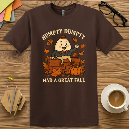 Dark Chocolate Color T-shirt with "Humpty Dumpty Had a Great Fall" design featuring a cute egg character, fall leaves, pumpkins, and seasonal wordplay.