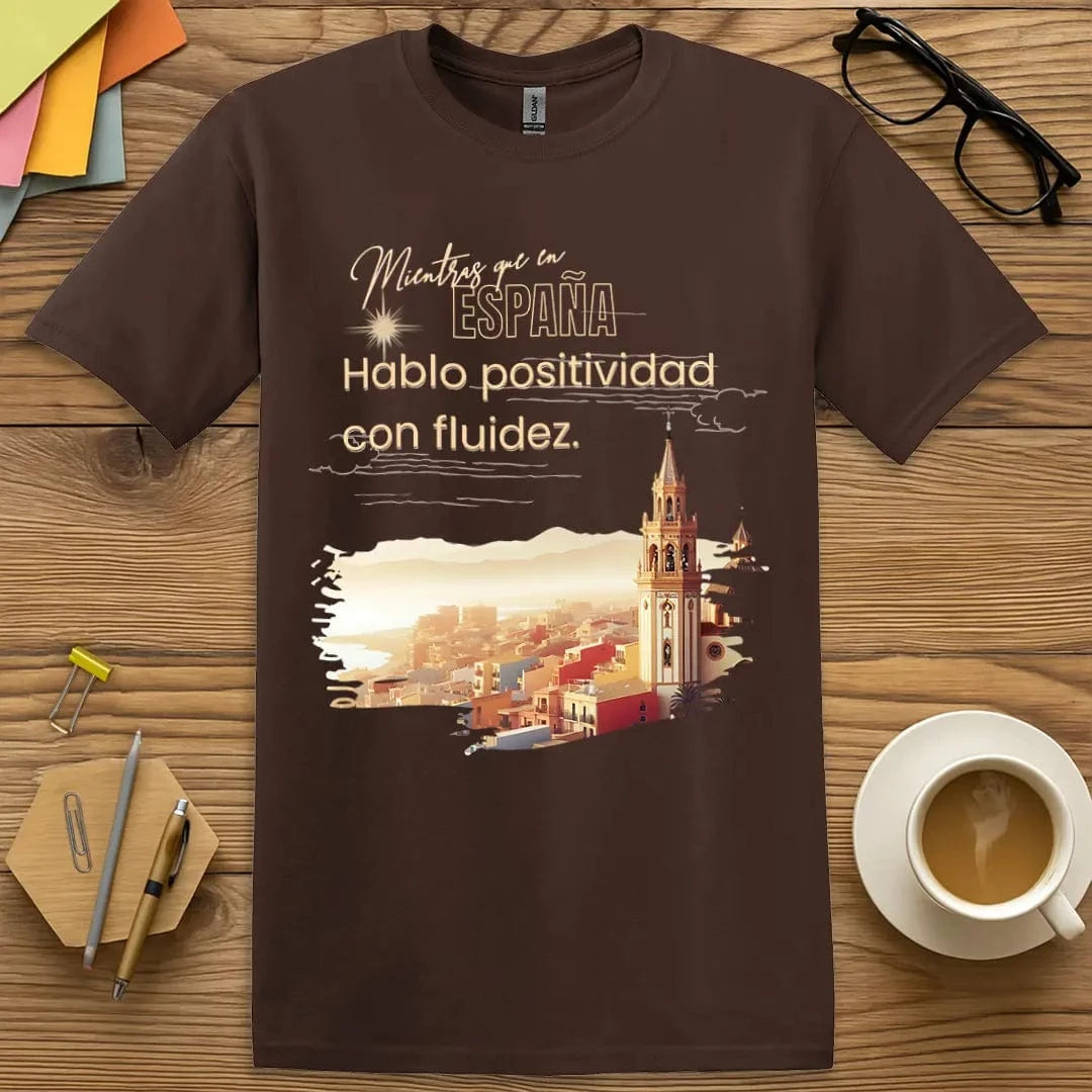 Dark Chocolate T-shirt with “Mientras que en España, Hablo positivo con fluidez” design featuring rich tones and clever classroom flair