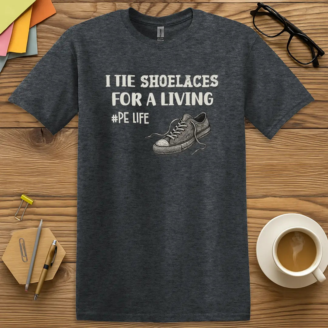 Dark Heather Color T-Shirt with "I Tie Shoelaces for a Living #PE Life" design featuring vintage sneakers and bold block text for physical education humor.