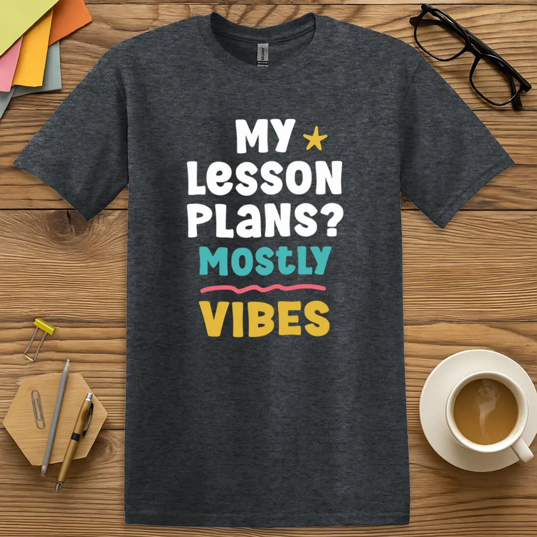Dark Heather Color T-shirt with "My Lesson Plans? Mostly Vibes" design delivering casual chaos charm for educators.