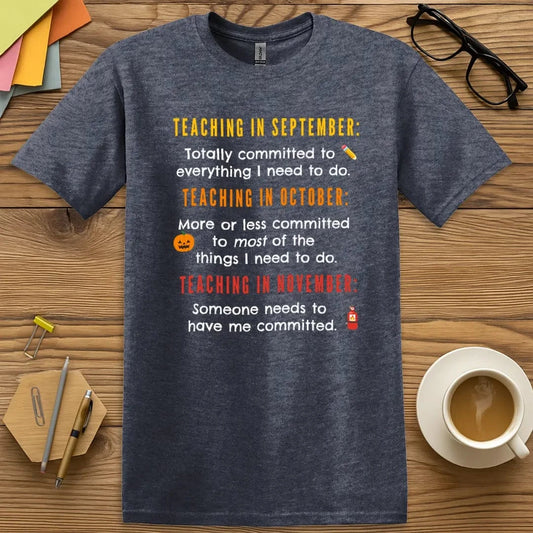Heather Navy T-shirt with “Totally Committed” design showing the emotional descent of the school year in bold, relatable style  