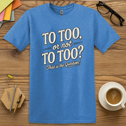 Heather Royal Color T-shirt with "To Too, or not To Too? That is the Question!" design featuring bold vintage text and grammar nerd flair.
