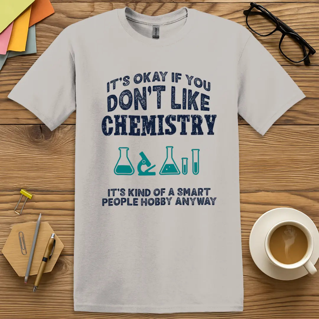 Ice Grey Color T-shirt with It’s Okay if You Don’t Like Chemistry, It’s Kind of a Smart People Hobby Anyway design featuring bold navy text and science icons for sarcastic science flair.