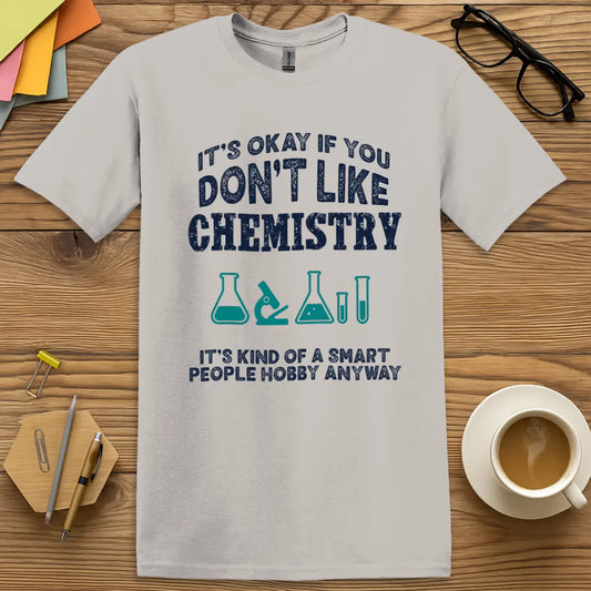 Ice Grey Color T-shirt with It’s Okay if You Don’t Like Chemistry, It’s Kind of a Smart People Hobby Anyway design featuring bold navy text and science icons for sarcastic science flair.