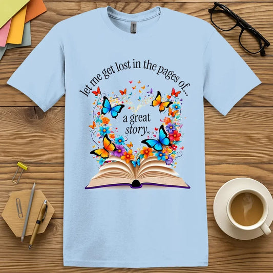 Light Blue Lost In The Pages T-Shirt – Whimsical butterflies and vibrant flowers burst from an open book, capturing the magic of getting lost in a story.