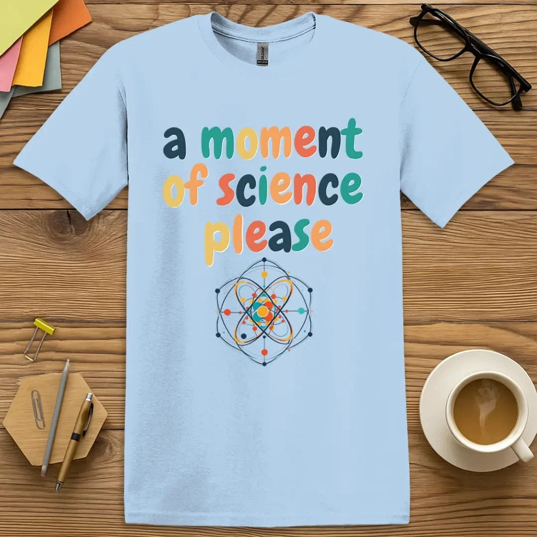 Light blue science teacher shirt – colorful text A Moment of Science Please – with atomic model graphic