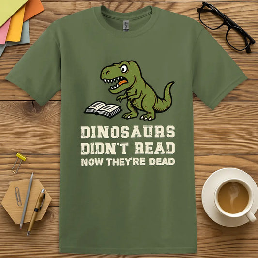 Military Green T-shirt with "Dinosaurs Didn't Read Now They're Dead" design featuring cartoon T-Rex and open book, bold extinction humor for educators.