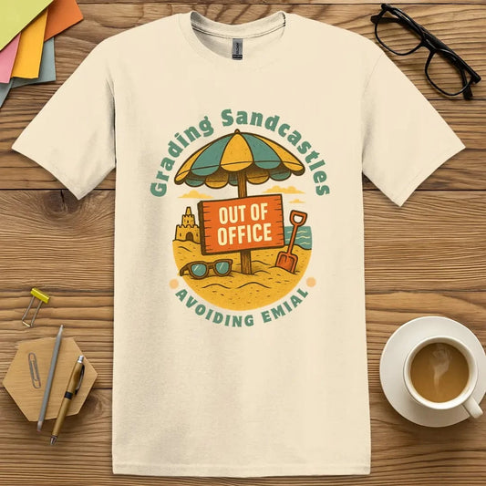 Natural T-shirt with “Out of Office: Grading Sandcastles, Avoiding Email” design — beach-themed educator humor with vacation vibes