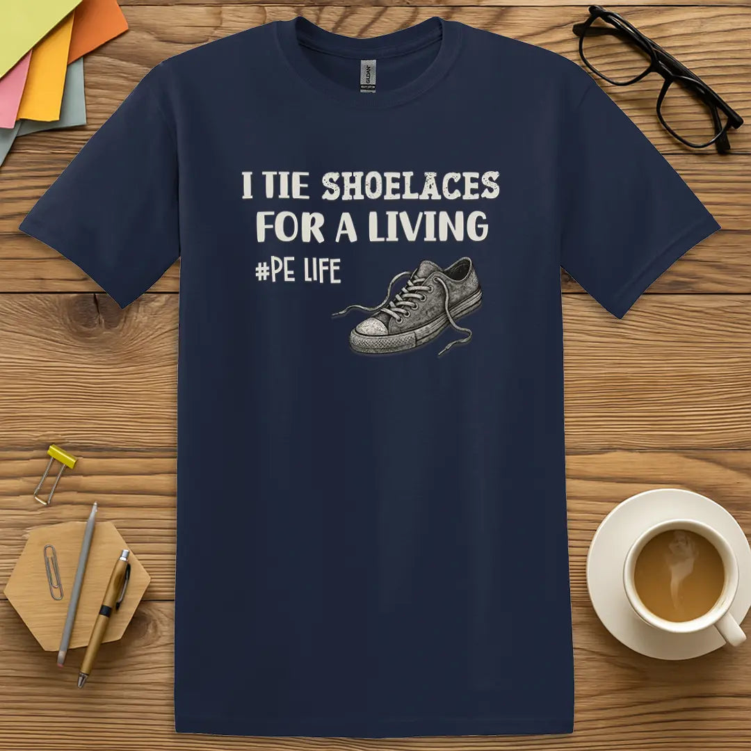 Navy Color T-Shirt with "I Tie Shoelaces for a Living #PE Life" design featuring classic gym teacher humor and sneaker illustration.