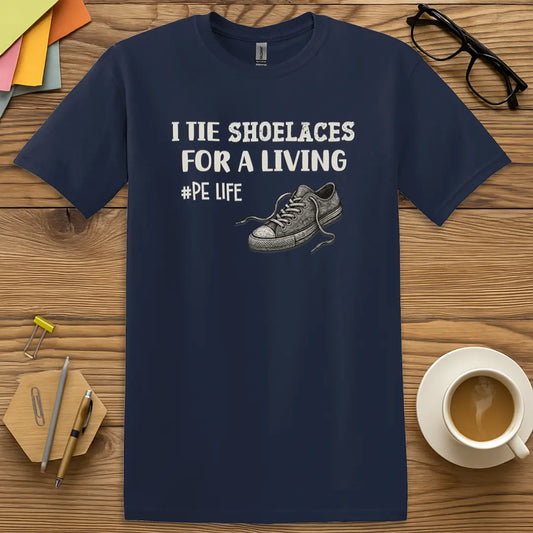 Navy Color T-Shirt with "I Tie Shoelaces for a Living #PE Life" design featuring classic gym teacher humor and sneaker illustration.