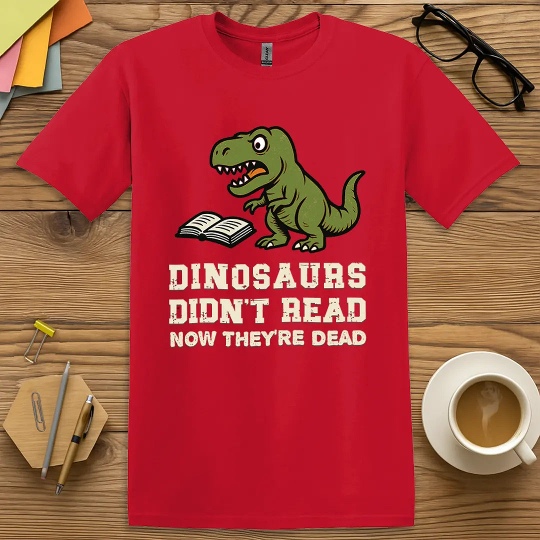 Red T-shirt with "Dinosaurs Didn't Read Now They're Dead" design mixing fiery color with humorous extinction awareness for classrooms.