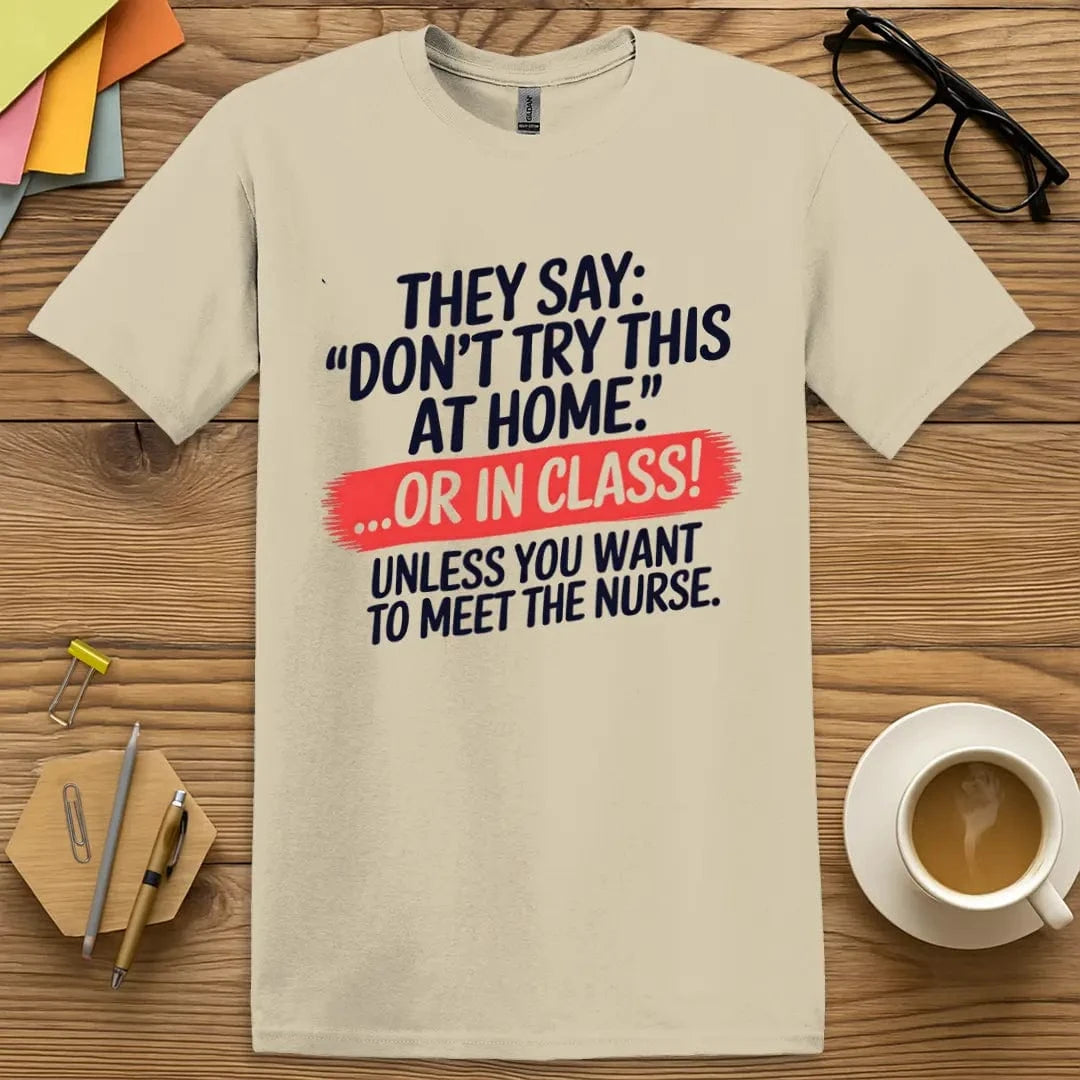 Sand T-shirt with “Don’t Try This at Home... OR IN CLASS!” design featuring bold safety-themed humor and playful educational warning