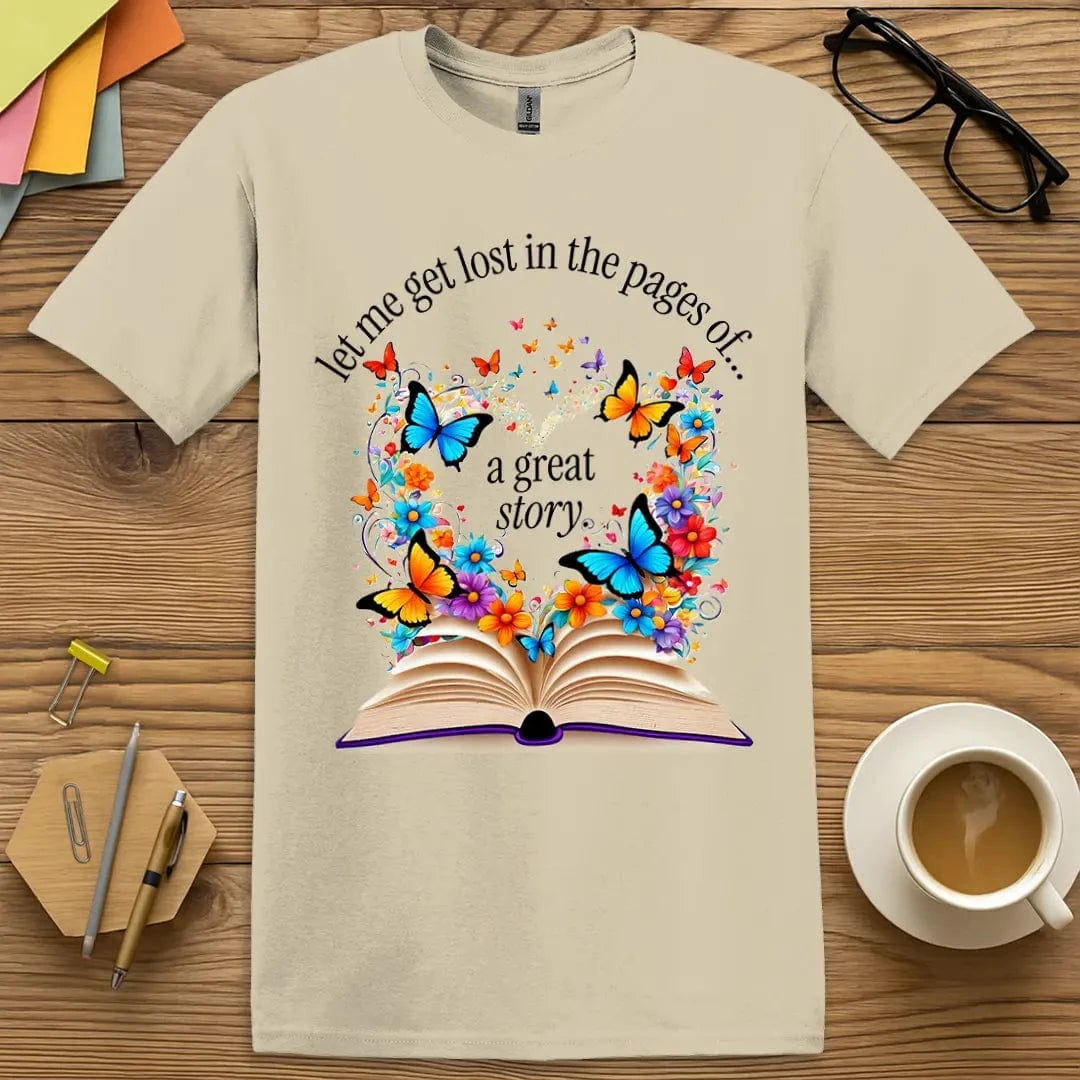 Sand Lost In The Pages T-Shirt – Earthy sand tone with vivid butterflies and flowers emerging from a book, ideal for teachers and readers alike.
