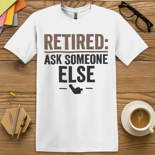 White T-shirt with “Retired: Ask Someone Else” design featuring bold classroom humor and passive-aggressive charm